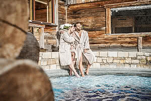 Couple at the pool in the 5 star wellness hotel STOCK resort Austria