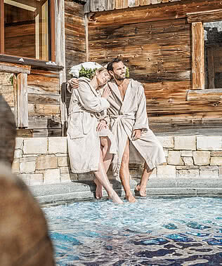 Couple at the pool in the 5 star wellness hotel STOCK resort Austria