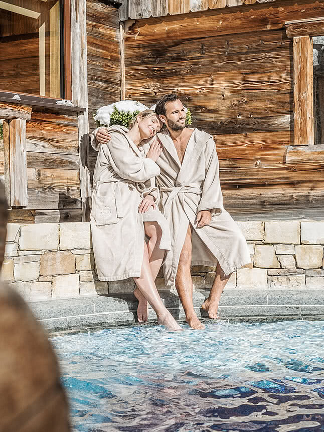 Couple at the pool in the 5 star wellness hotel STOCK resort Austria