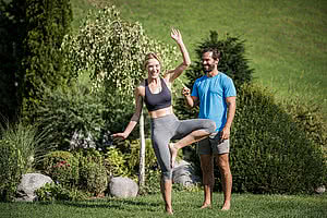 Couple doing yoga in the yoga hotel STOCK resort Austria