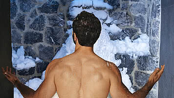 Man in the snow cave in wellness hotel STOCK resort