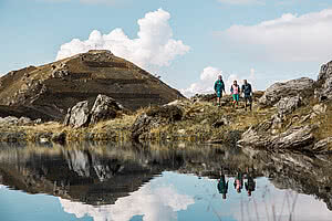 Hikers at the mountain lake on the Wimbachkopf during a hiking holiday in Zillertal