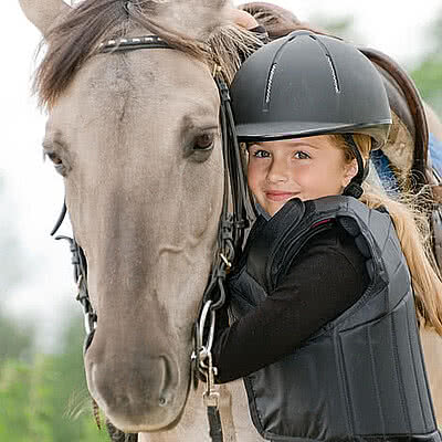 EIn Mädchen mit einem Pferd beim Reiten im Zillertal