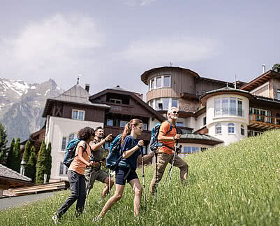 Hikers next to Sports Hotel STOCK resort Austria