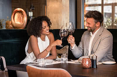 Couple enjoying wine in Gourmet Hotel STOCK resort