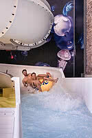 Father and son sliding in Family Hotel STOCK resort Austria