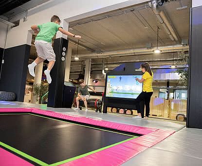 Children jumping on a trampoline in the Action Park in Tyrol STOCK resort