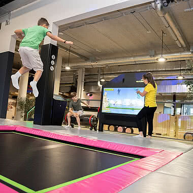 Children jumping on a trampoline in the Action Park in Tyrol STOCK resort