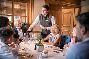 Waiter pouring wine in Restaurant STOCK resort