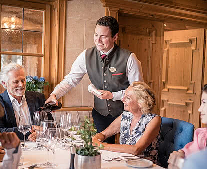 Waiter pouring wine in Restaurant STOCK resort