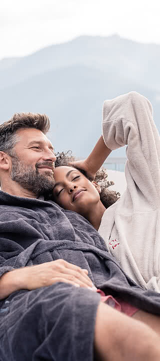 Couple on a lounger in a luxury hotel in Zillertal STOCK resort