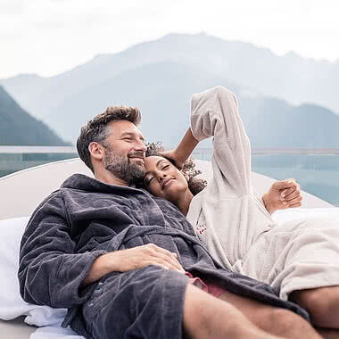 Couple on a lounger in a luxury hotel in Zillertal STOCK resort