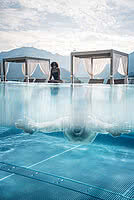 Woman at pool in 5-Star Wellness Hotel STOCK resort Austria