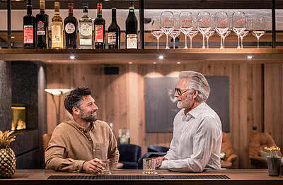 Men at the bar in Gourmet Hotel Austria STOCK Resort